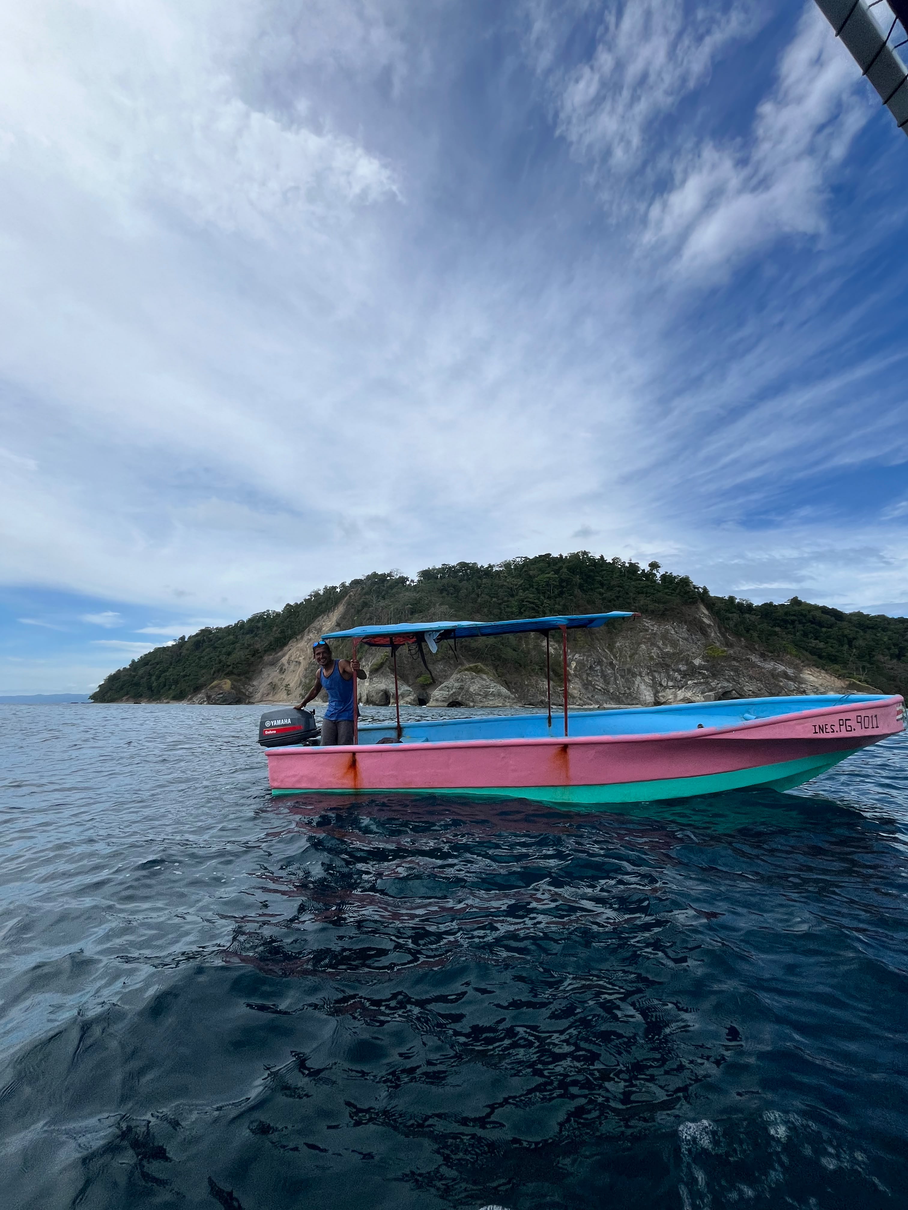 A panga anchored beside a small jungle island in Golfo Dulce