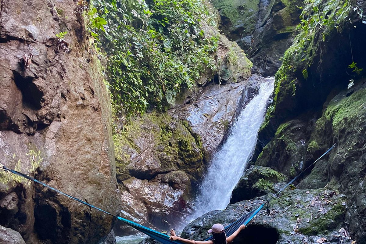 A waterfall spilling into a jungle pool on the La Hierba hike near Pavones