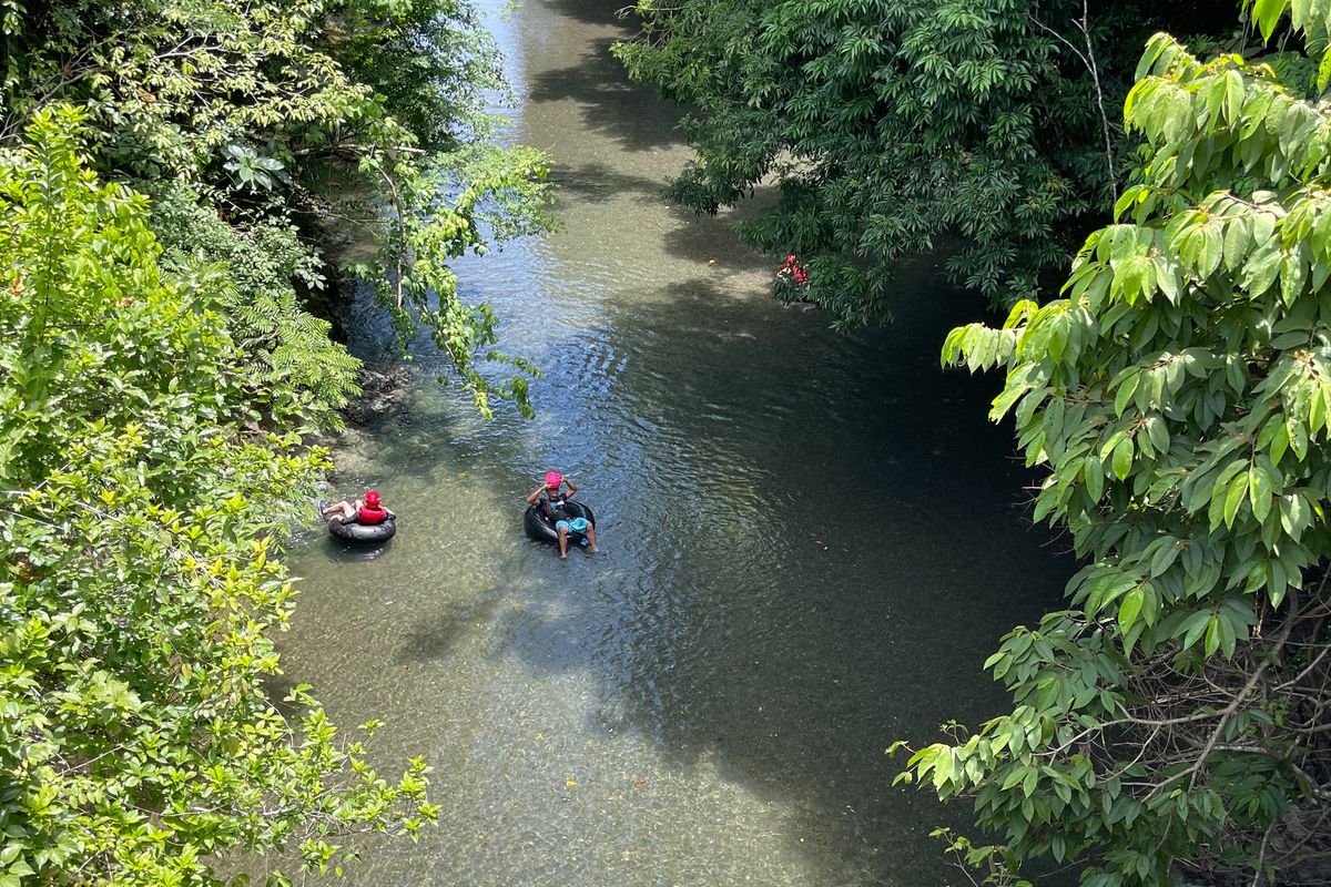 Tubers floating down a jungle river near Pavones, Costa Rica