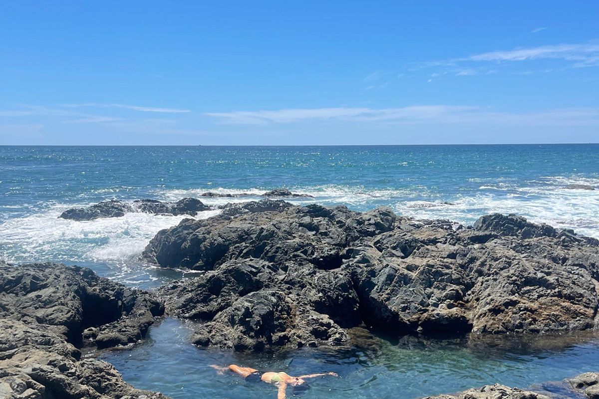 A natural tidal pool between rocks on the coast near Pavones